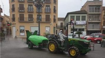 Tractor equipped with Smartomizer disinfecting the streets